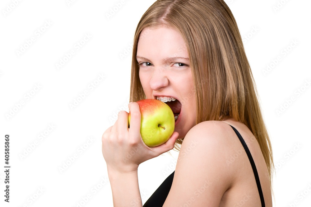 Beautiful young woman with brackets on teeth eating the apple Beautiful young woman with brackets on teeth eating the apple