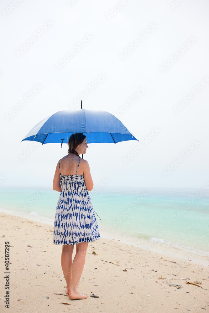 Woman at beach under rain