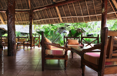 Beautiful resort with chairs, table and exotic trees