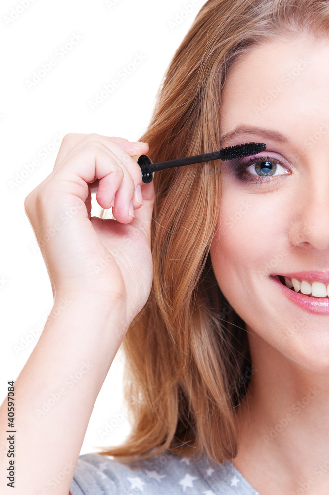 close up portrait of smiley woman doing make up
