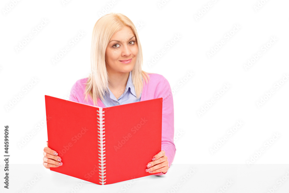 A happy female student reading a book A happy female student reading a book