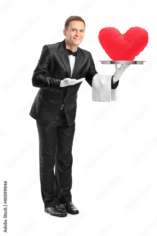 Butler holding a tray with a red heart shape on it Butler holding a tray with a red heart shape on it