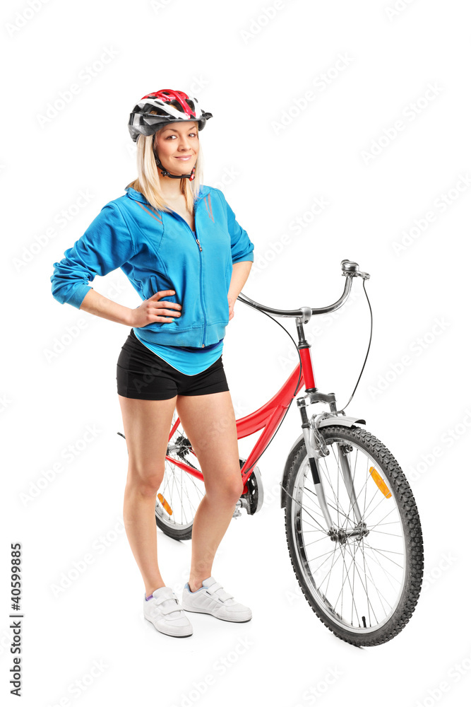 Female biker with helmet posing next to a bike Female biker with helmet posing next to a bike