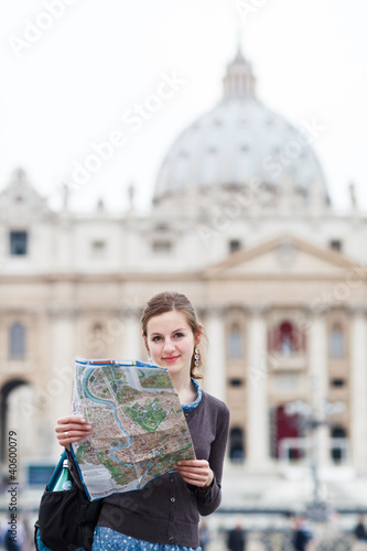 Pretty young female tourist studying a map at St. Peter's square © lightpoet