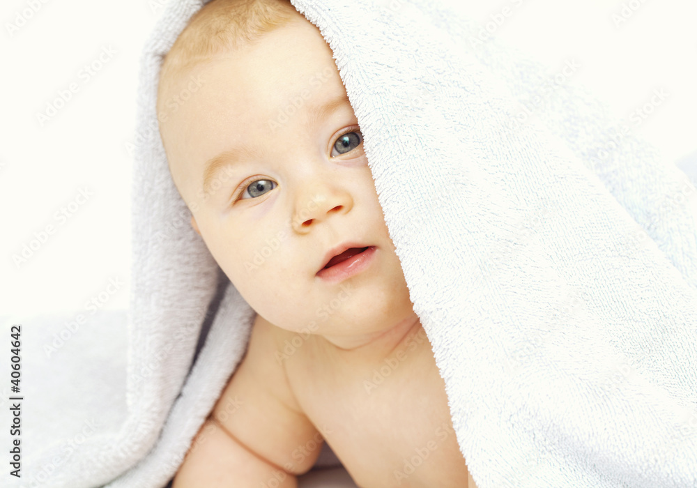 baby is looking from under the towel baby is looking from under the towel