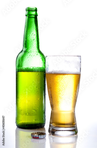 Green bottle and Half drank beer mug isolated on white backgroun