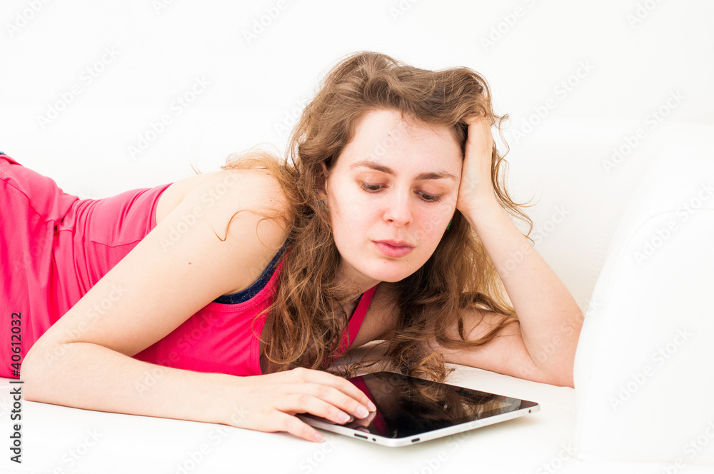 Obraz premium woman with touch screen tablet computer on sofa