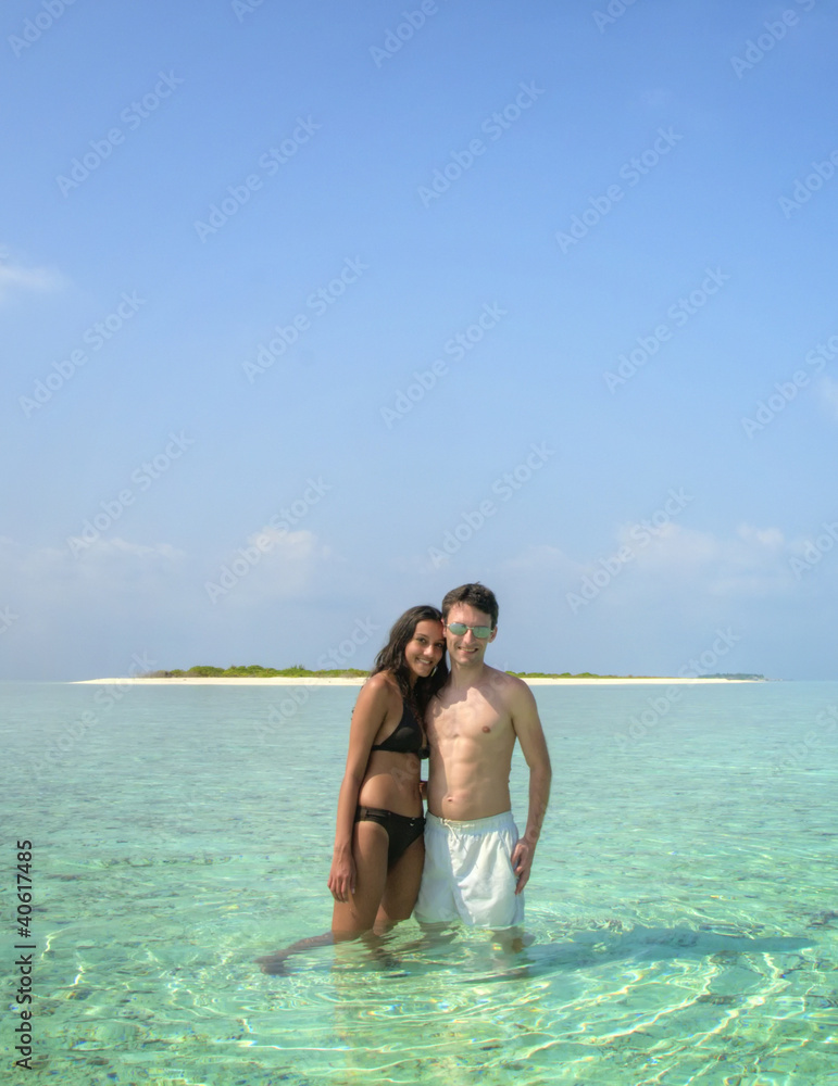 Sensual happy lovers standing in the Lagoon (Maldives)