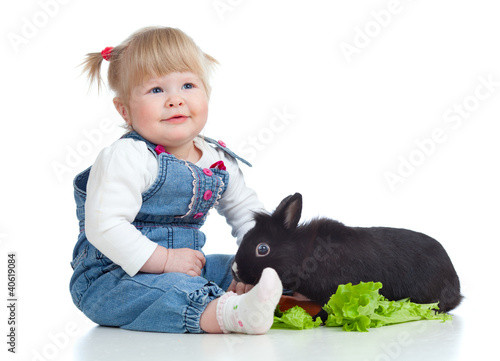 Funny little girl feeding a...