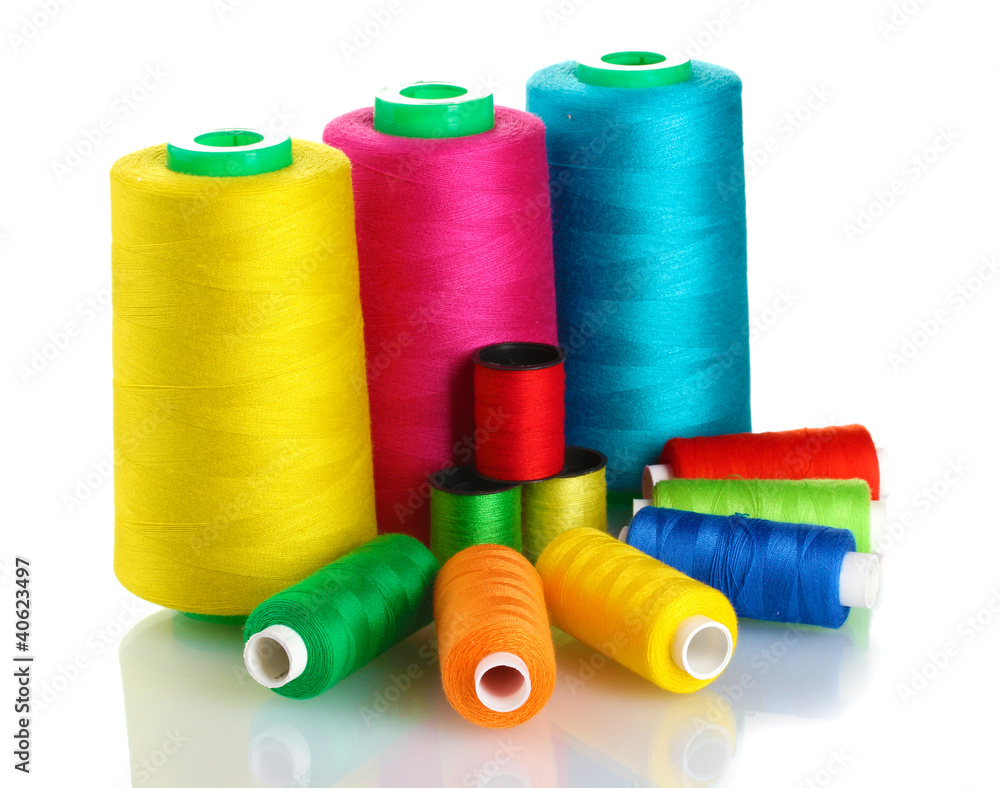 Many-coloured bobbins of thread isolated on white Many-coloured bobbins of thread isolated on white