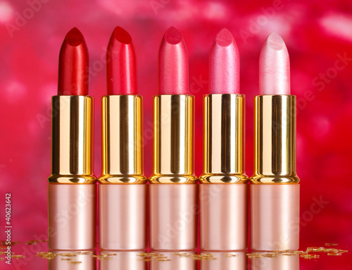 beautiful lipsticks on red background