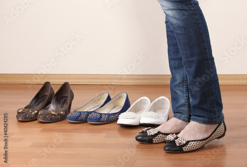Woman in ballet flat shoes on wooden background