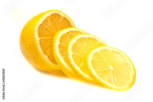 Lemon slices and lemon on white