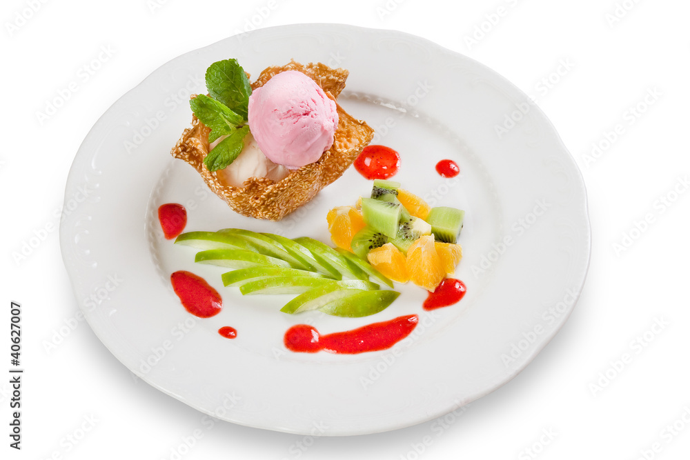 Ice cream in krokant basket with sauce on plate Ice cream in krokant basket with sauce on plate