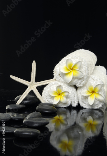 spa image of frangipani flowers with roller towels –still life