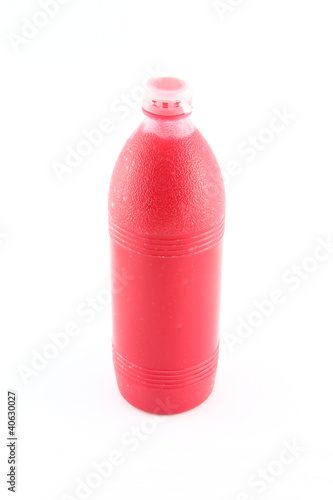 Red sauce plastic bottle on white background.