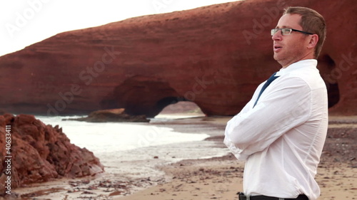 Businessman relaxing on beautiful Legzira beach photo