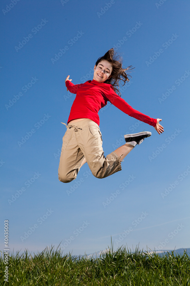 Girl jumping, running against blue sky Girl jumping, running against blue sky