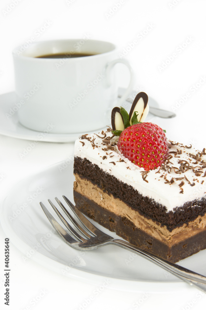 Piece of chocolate cake with strawberry decorate on top and cup Piece of chocolate cake with strawberry decorate on top and cup