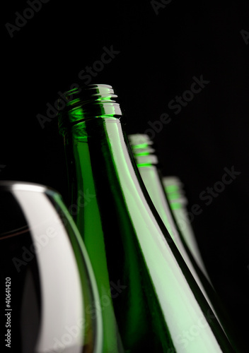 bottles with glass on black background