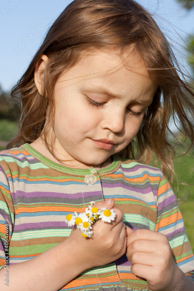 child with chamomiles