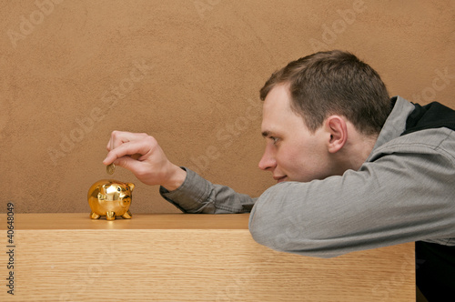 man saves money in his piggy bank
