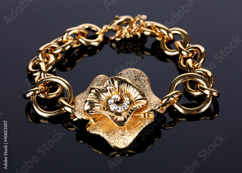 Beautiful golden bracelet with precious stones