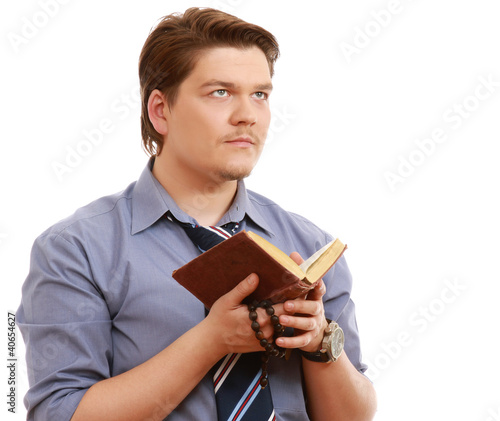 Closeup of a man praying looking up. View from aside