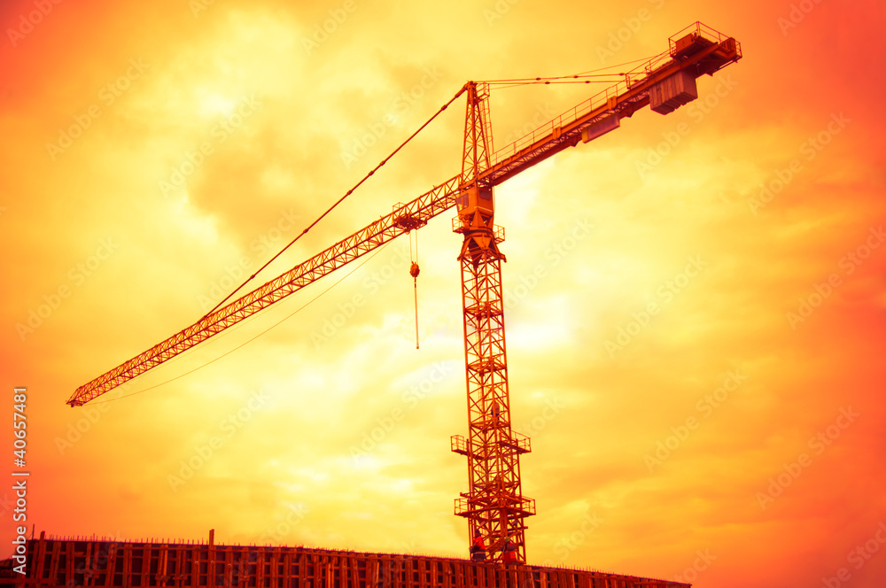 big crane on the sunset orange sky background big crane on the sunset orange sky background