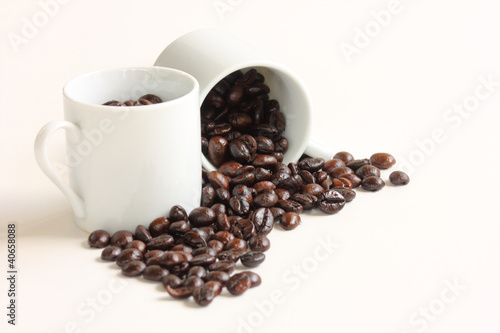 Coffee beans with a white ceramic cup