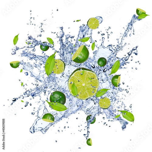 Limes pieces in water splash, isolated on white background