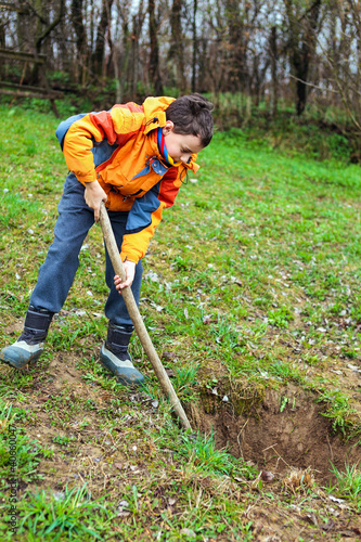 Boy digging in the ground