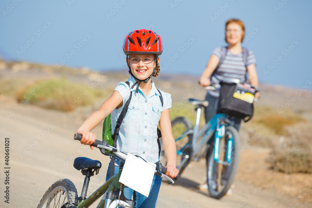 Fototapeta premium girl and her grandmother on bikes