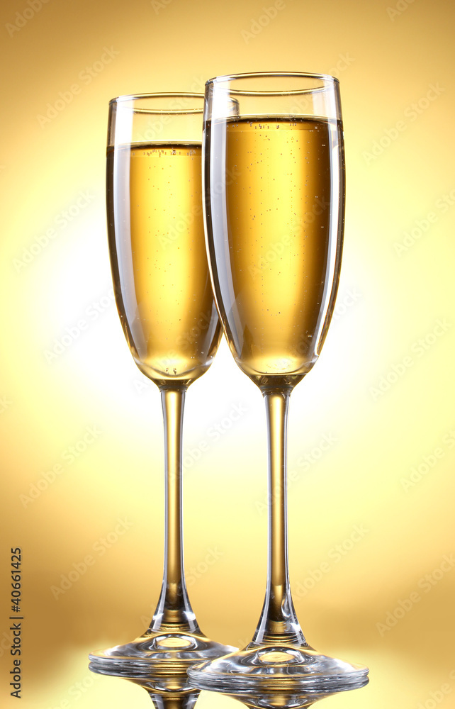 glasses of champagne on yellow background glasses of champagne on yellow background