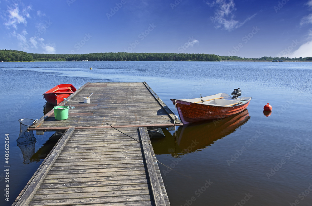Boats moored to wooden platform on Chancza lake