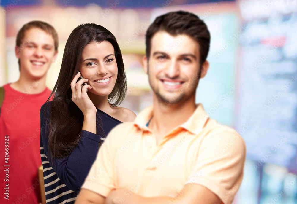 young friends smiling and one girl talking on mobile over abstra young friends smiling and one girl talking on mobile over abstra