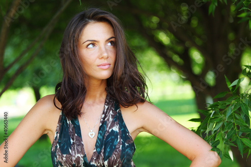 girl on a background of green trees