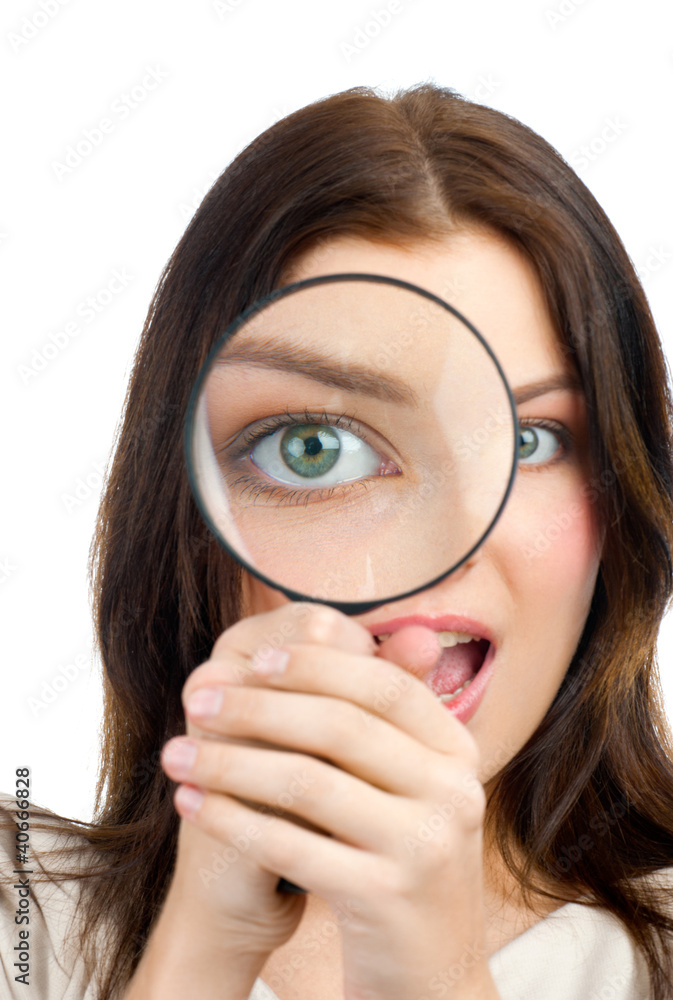 Woman looking through a magnifying glass Woman looking through a magnifying glass