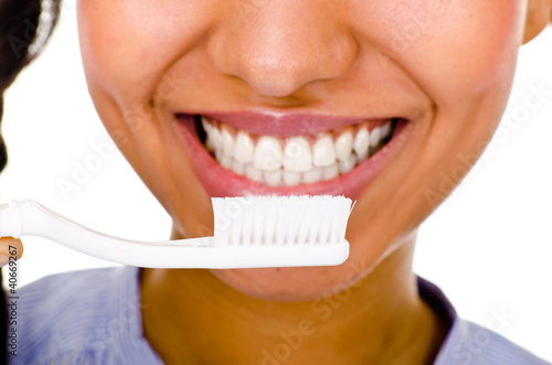 Afro-american girl brushing her teeth