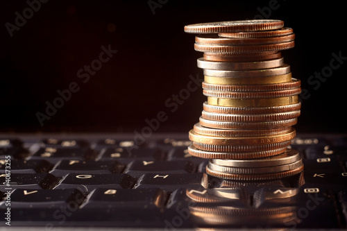 a coin pile over a keyboard photo