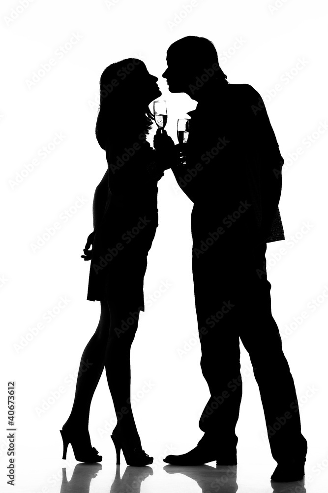 Silhouette of a happy couple with wine glasses as logo