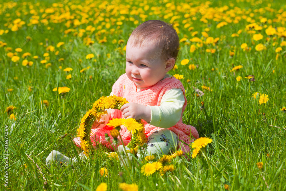 little girl in a pink dress plays to a glade with dandelions little girl in a pink dress plays to a glade with dandelions