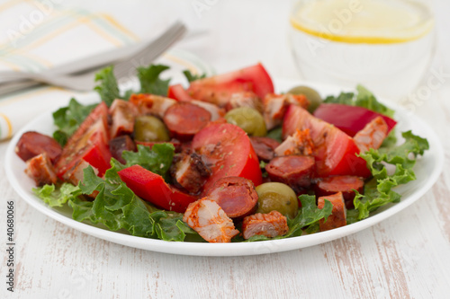 salad with meat and olives on the plate