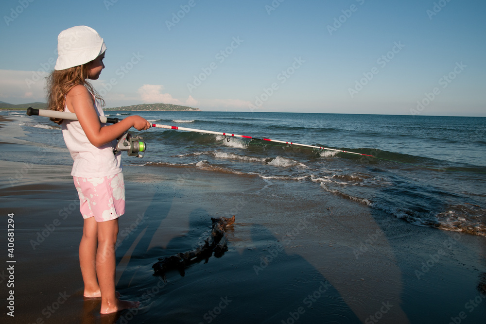 Fishing - girl fishing at the beach Stock Photo