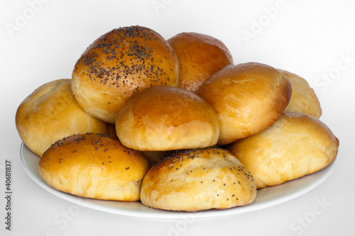 fresh breakfast rolls on a plate with white background