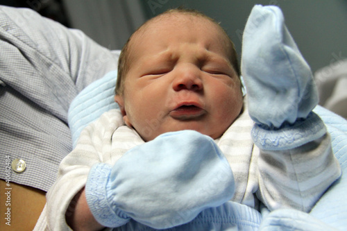 Newborn baby of three months old in his mothers hands