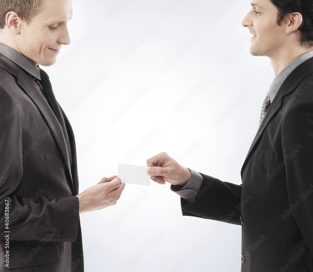 Two young businessmen holding a blank visit card Two young businessmen holding a blank visit card
