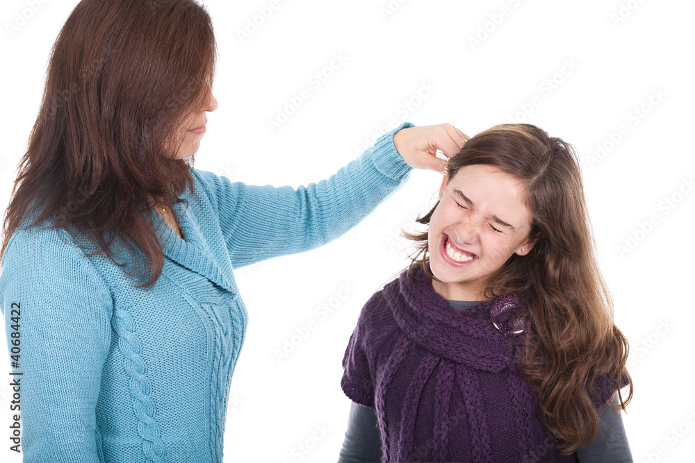 mother pulling her daughter's ear and punishing her Photos | Adobe Stock