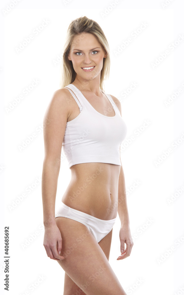A young and fit blond Caucasian woman in white lingerie A young and fit blond Caucasian woman in white lingerie