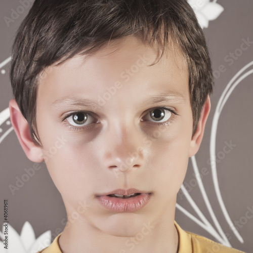 Bild auf Leinwand young boy looking at camera